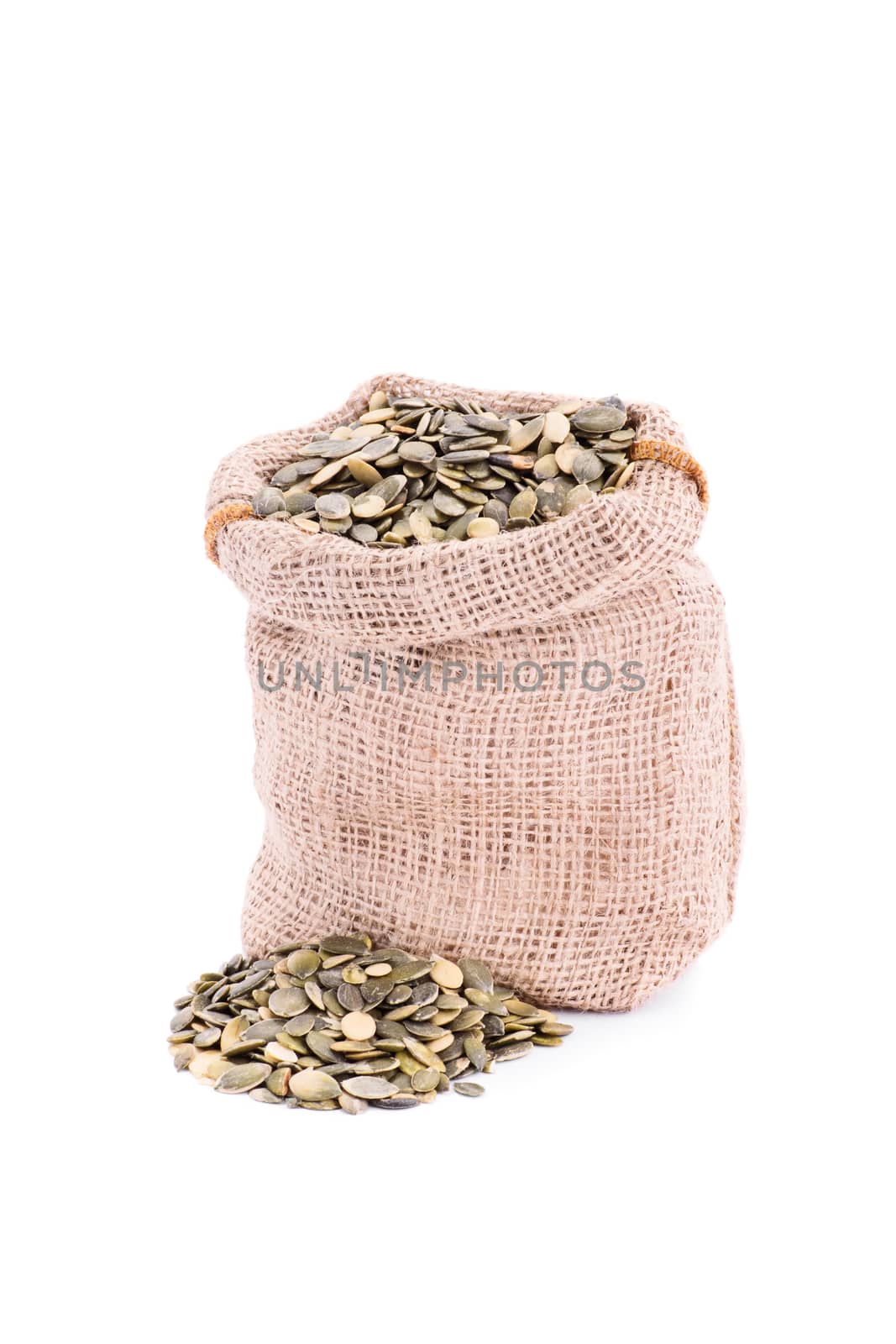Small burlap sack of fresh pumpkin seeds, isolated on white background.