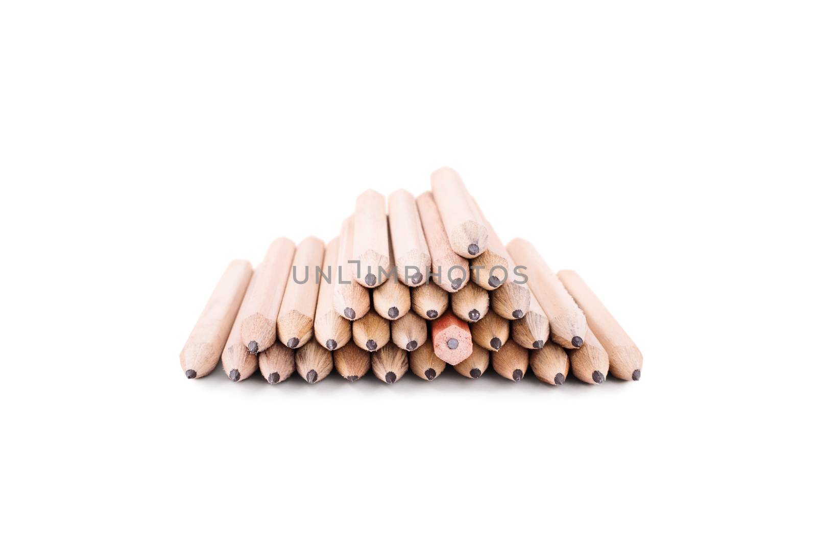 One makes a difference. Stack of pencils isolated on white background. One crayon among many pencils, turned in different direction.
