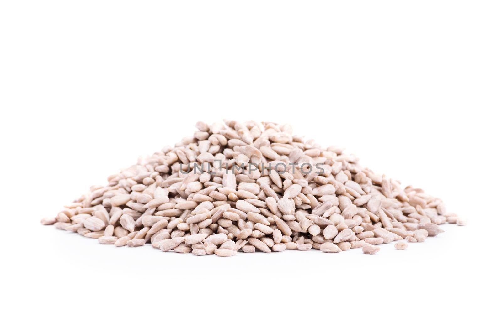 Close up shot of heap of sunflower seeds, isolated on white background.