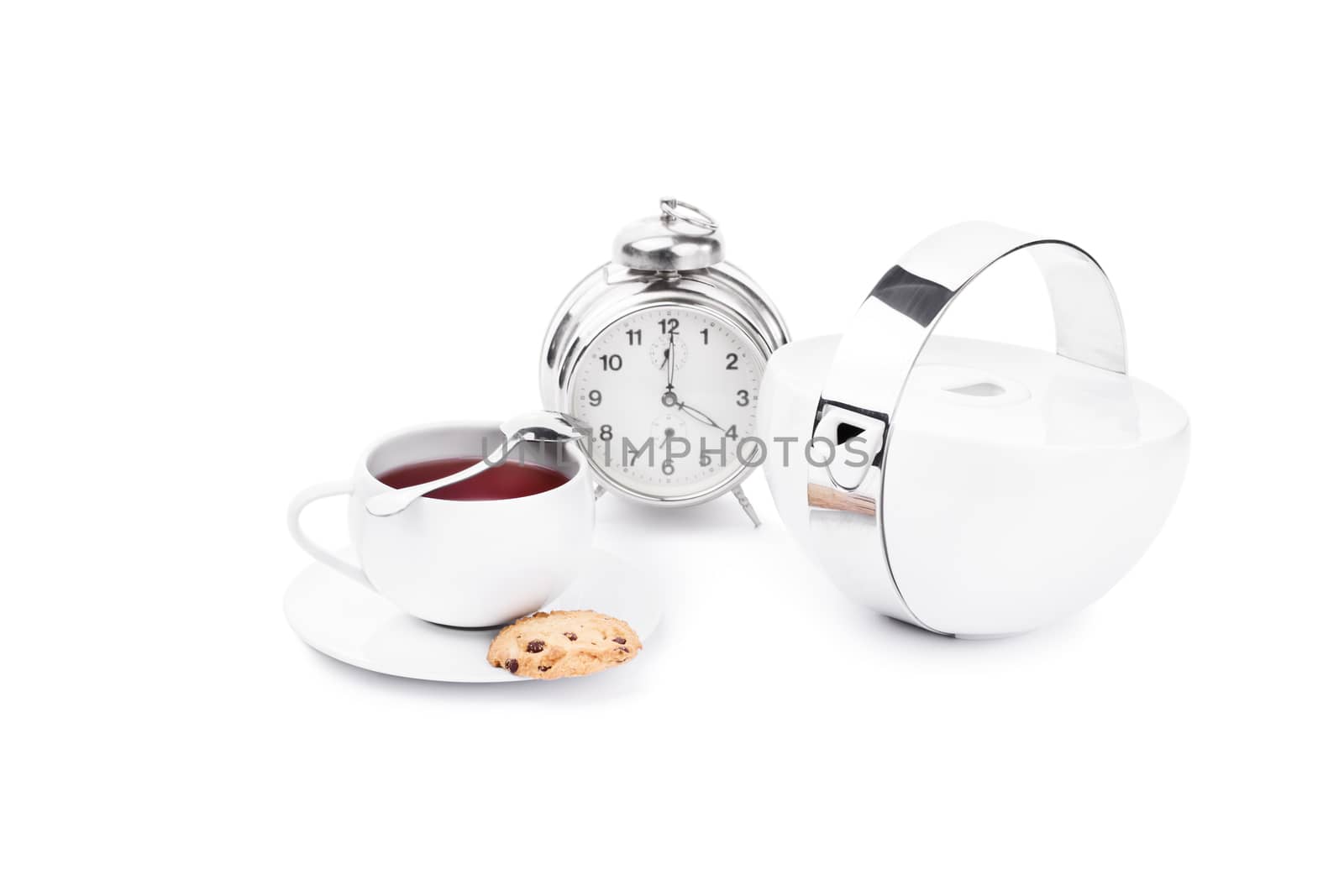 Cup of tea with chocolate cookies and an alarm clock,isolated on white background.