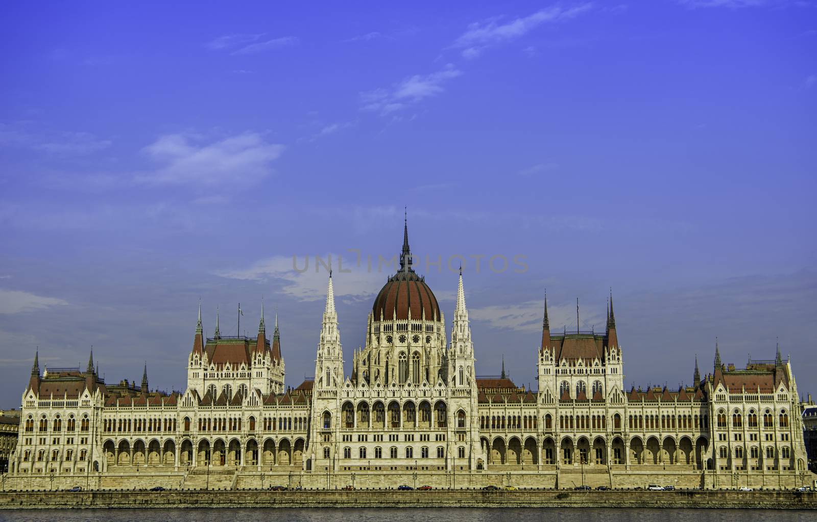Front view of the Hungarian Parliament building from the Danube side during the day.
