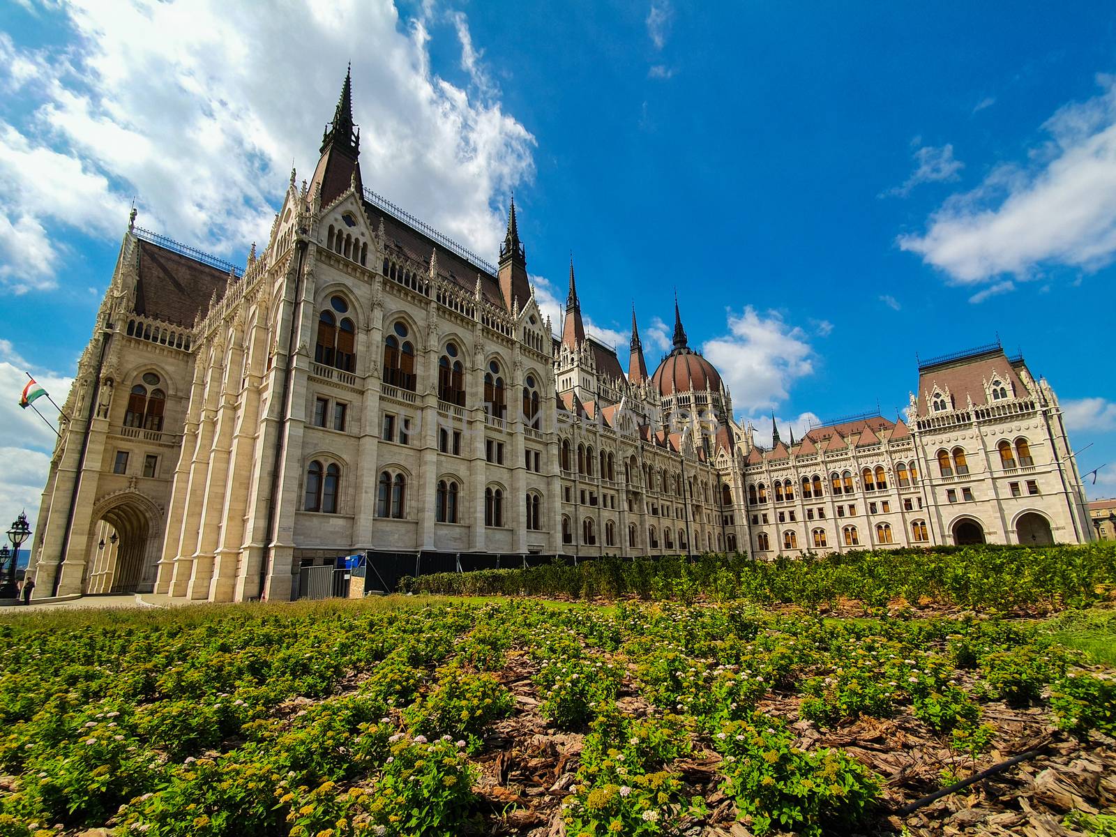 Panoramic view of the Hungarian parliament in Budapest on a beautiful summer day with clear blue sky. Side panoramic view of the Hungarian parliament in Budapest. 