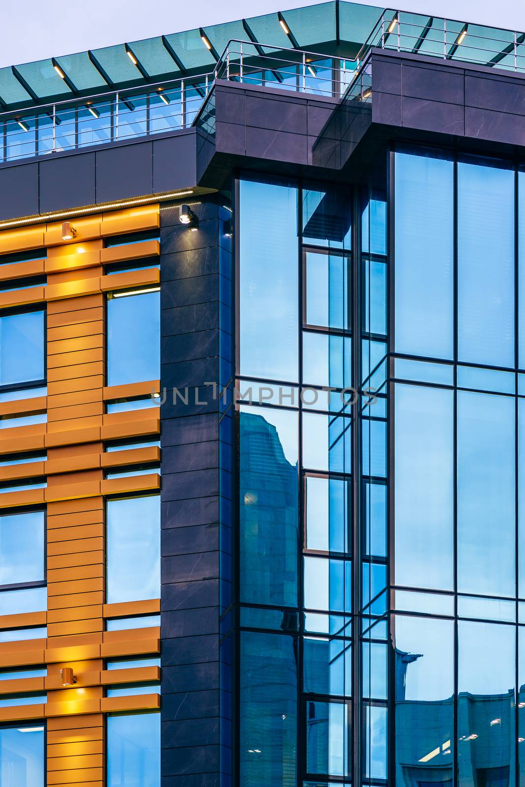 Modern high-rise office building with a glass facade, background.