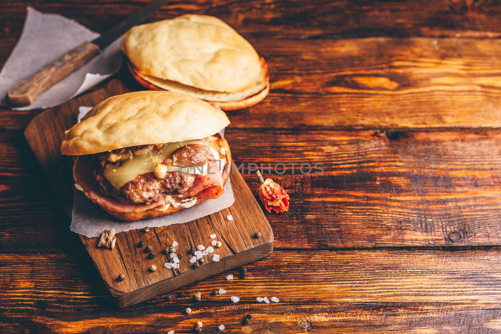 Cheeseburger with Beef Patty on Wooden Background and Copy Space.