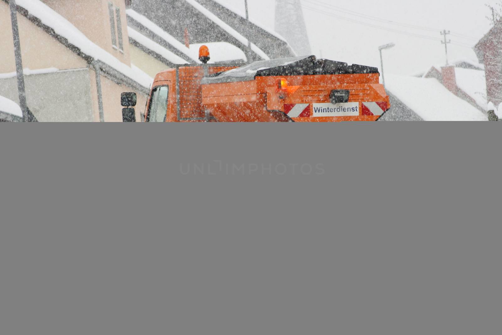 Winter service vehicle in use in heavy snow-fall  Winterdienstfahrzeug im Einsatz bei starkem Schneefall