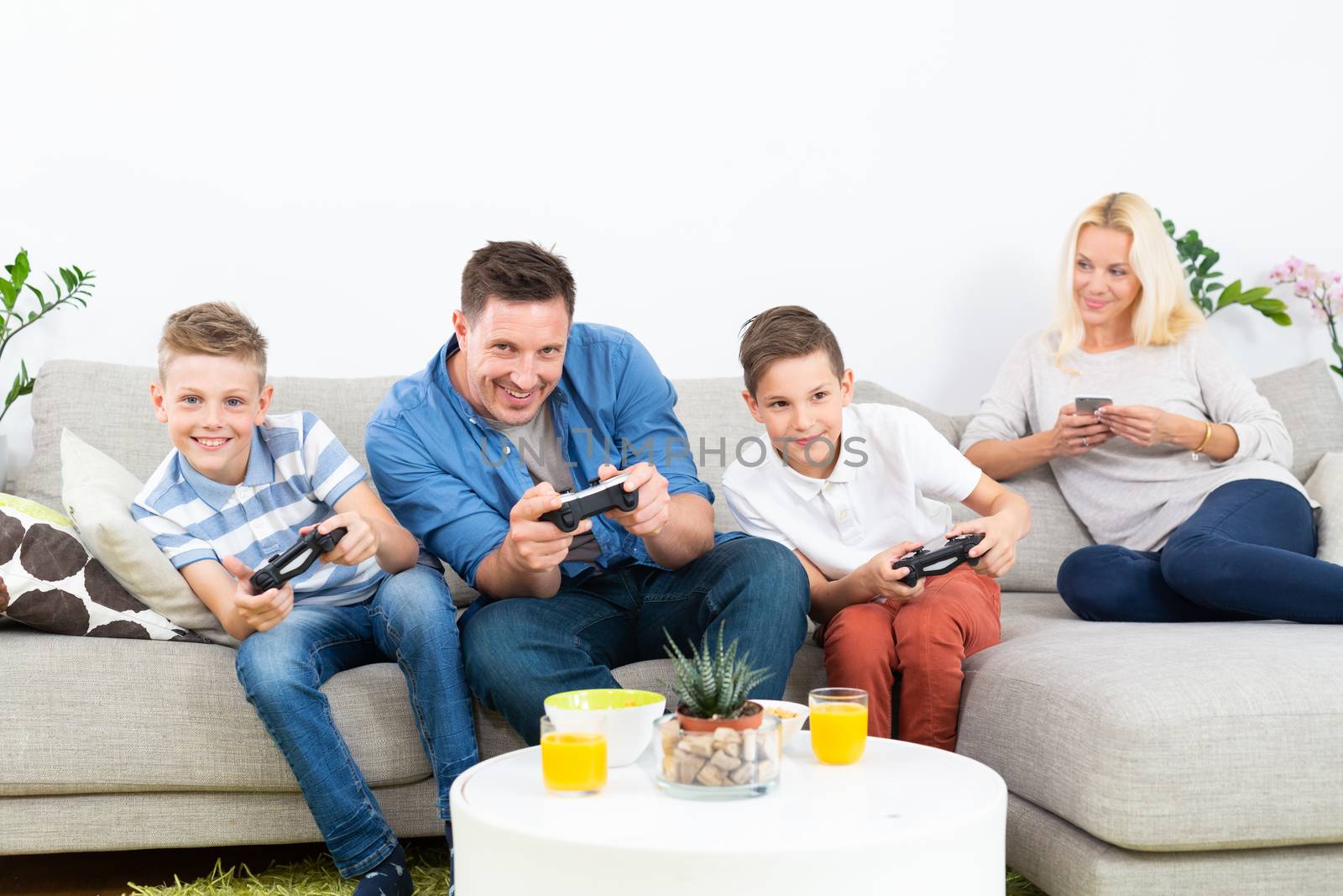 Happy young family playing videogame On TV. by kasto