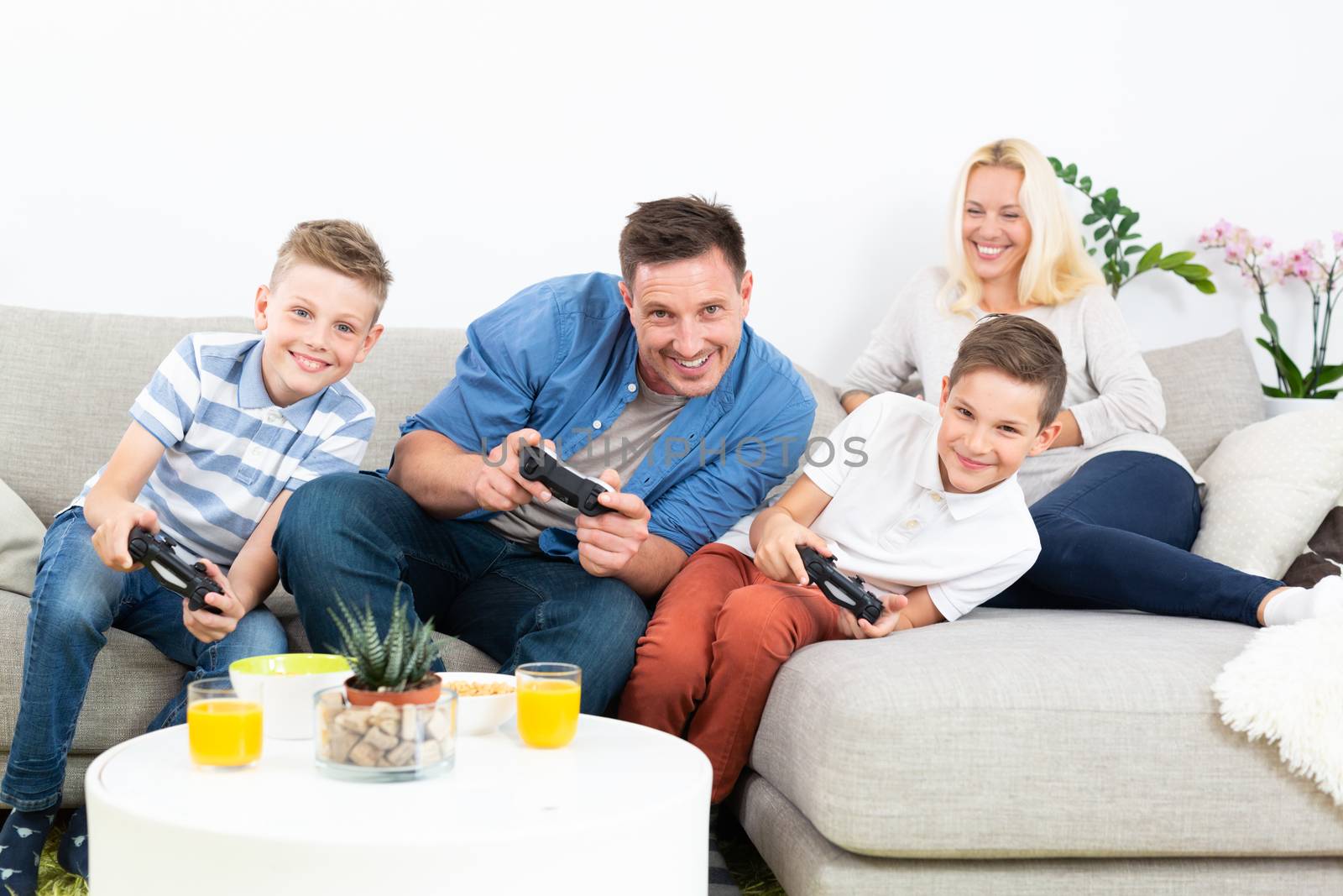 Happy young family playing videogame On TV. by kasto