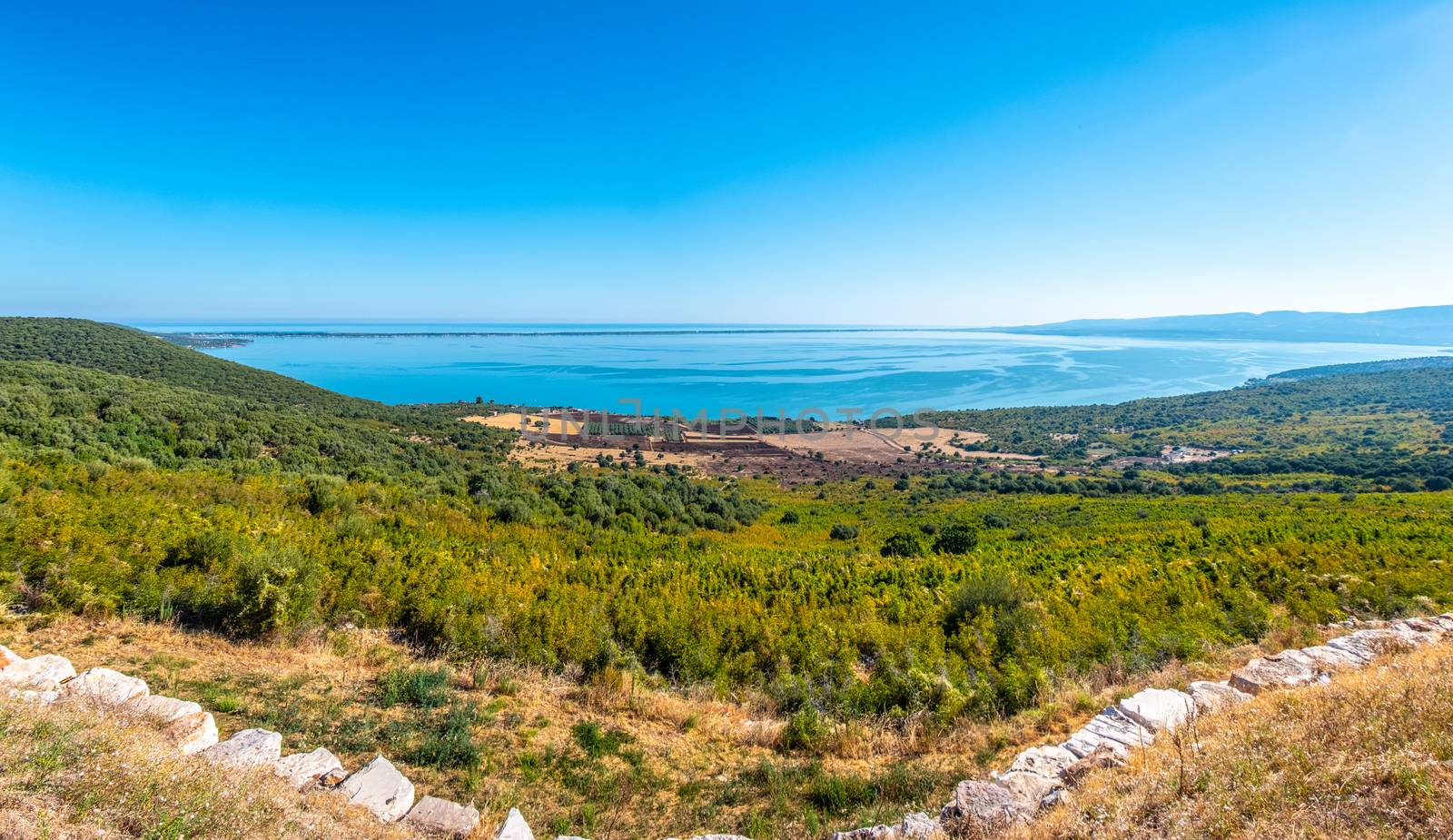 large panoramic of lake Varano in Gargano - Puglia - Italy - at the horizon the adriatic sea .