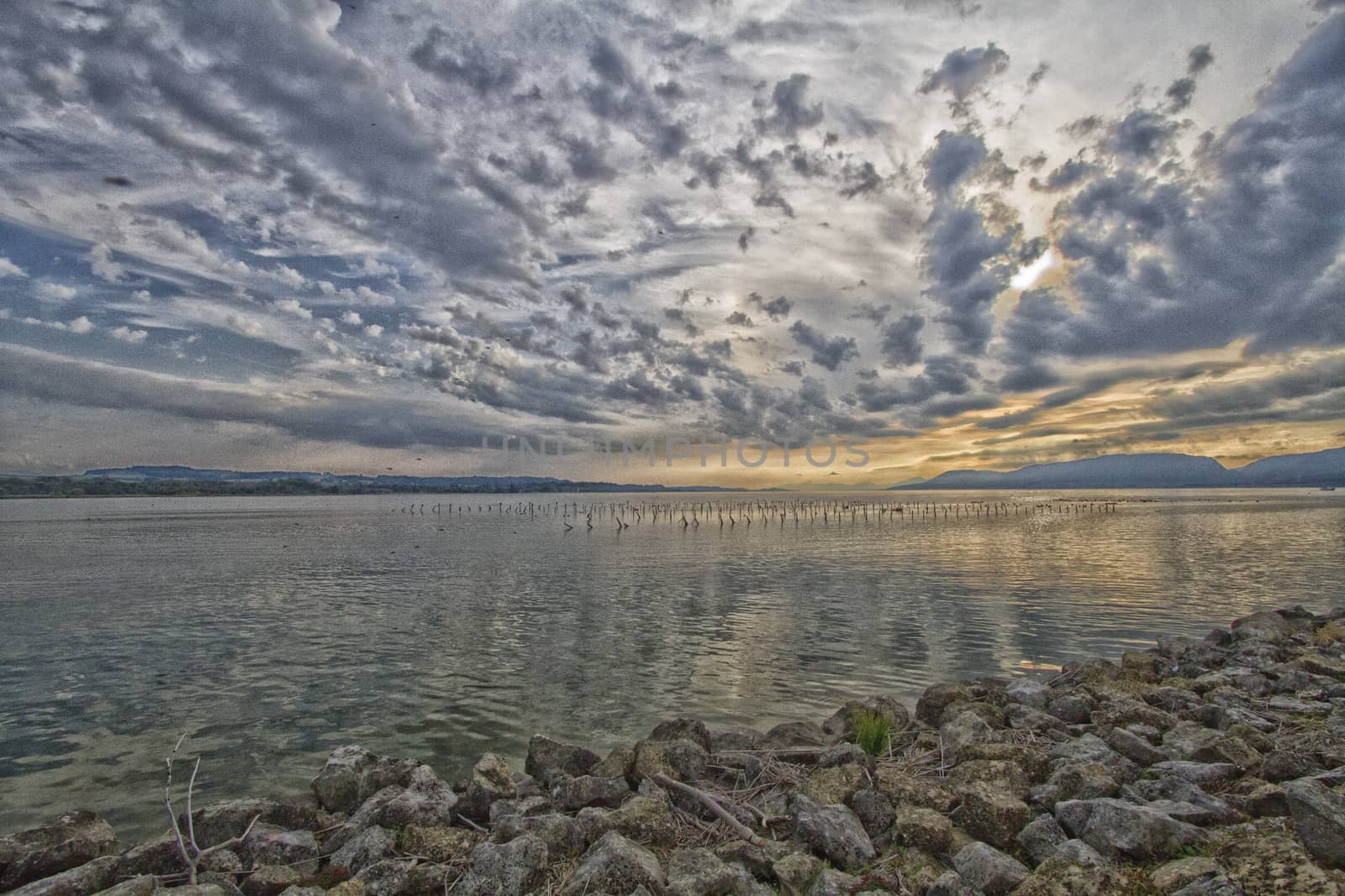 sunset on lake Neuchatel from Cudrefin switzerland by mariephotos