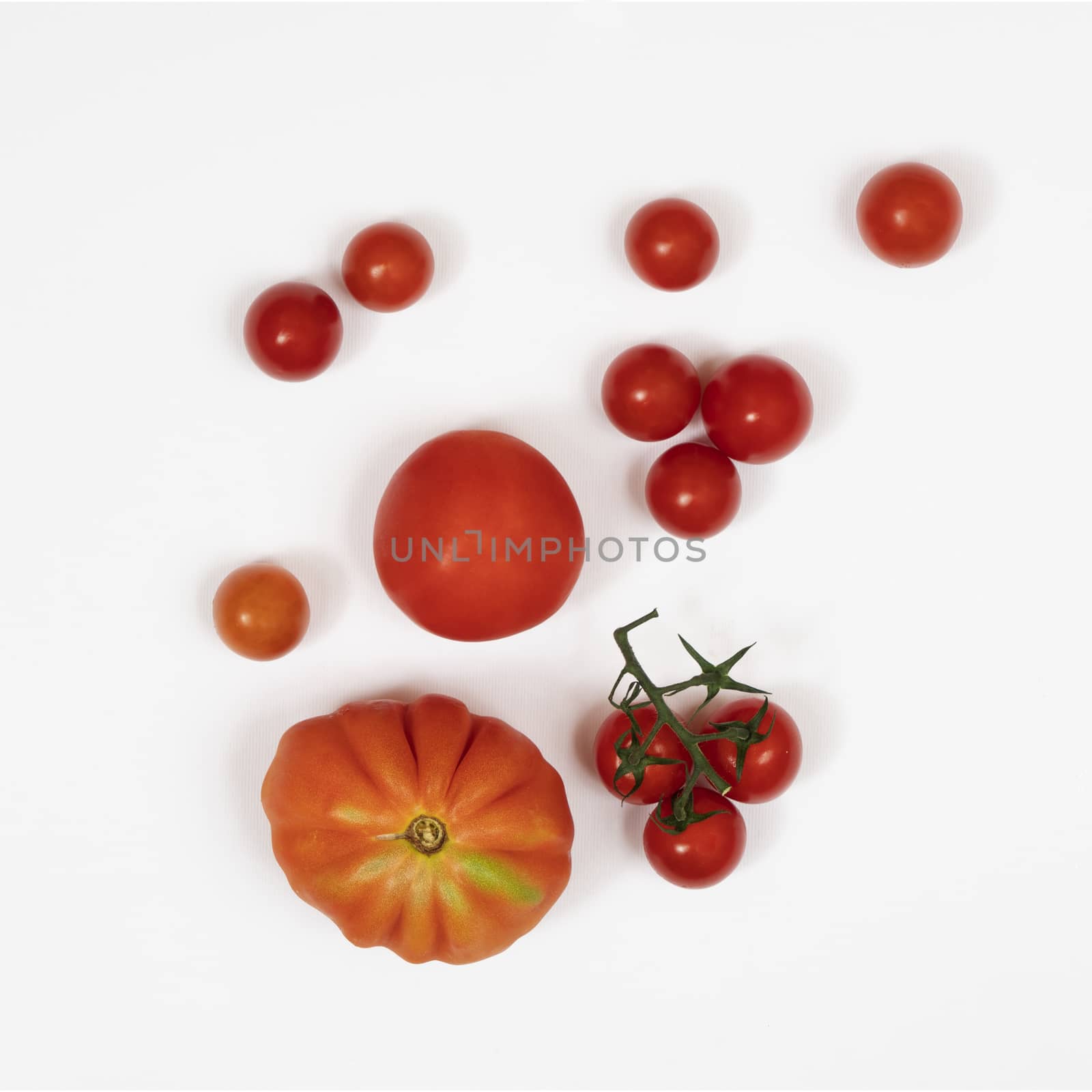 some types of tomatoes on a white surface