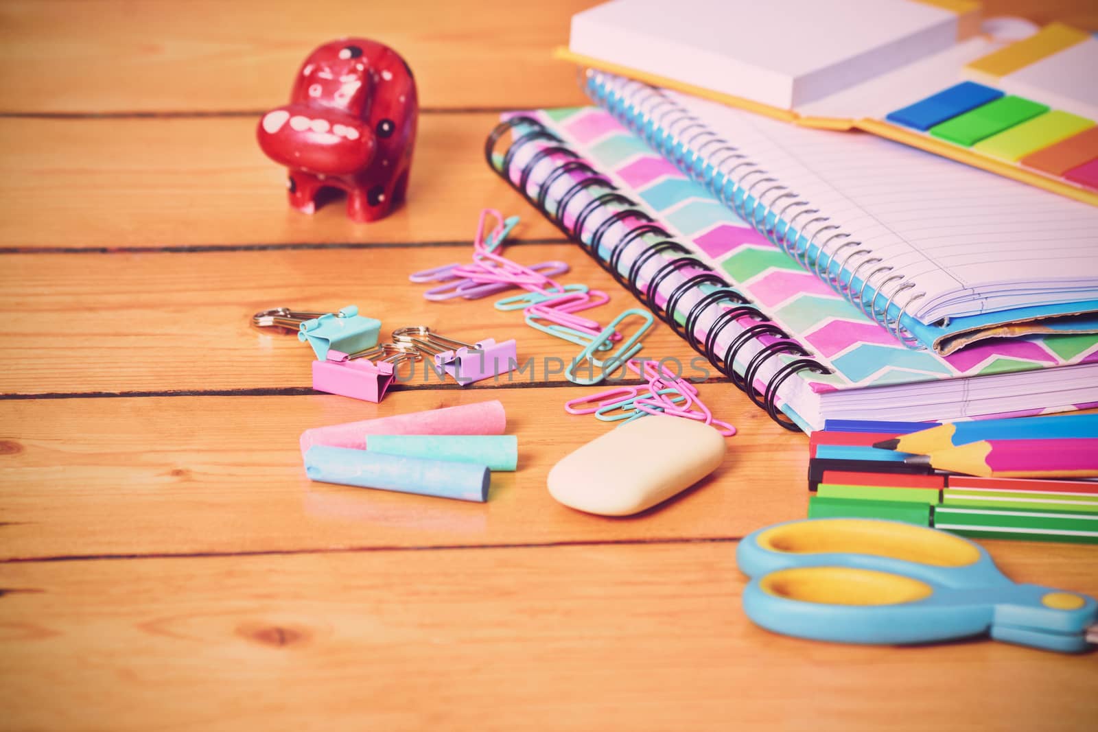 Cute school stationary on wooden background by Mendelex
