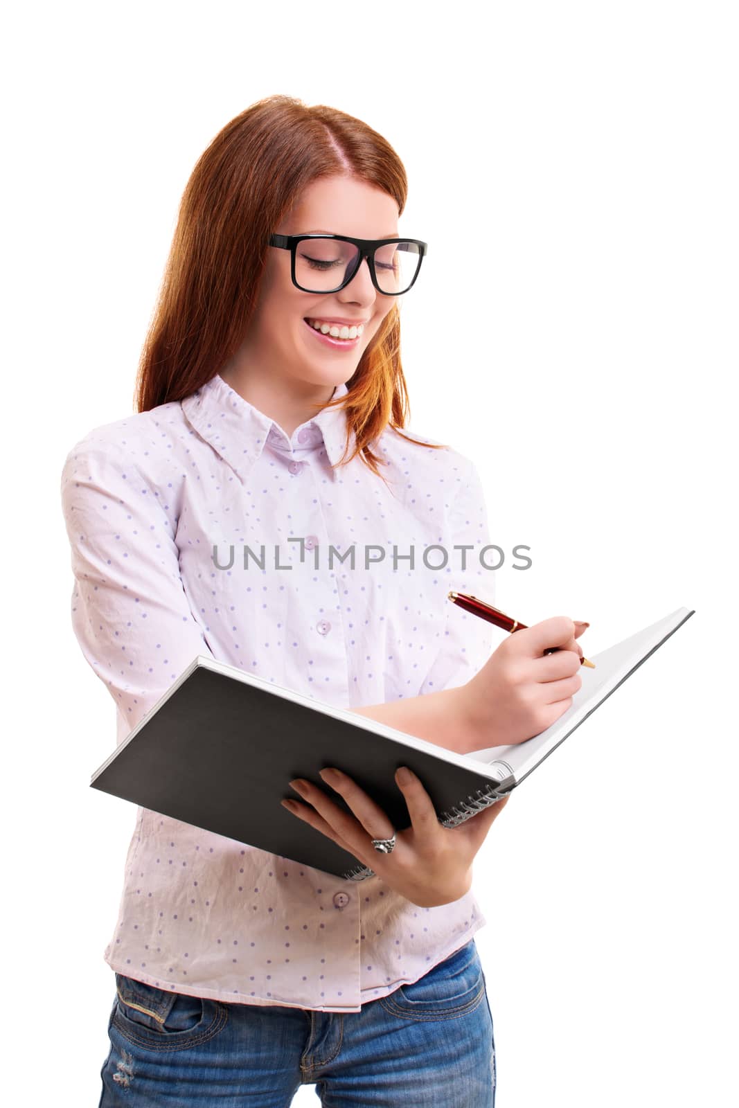 beautiful smiling young woman holding a notebook and taking notes, isolated on white background