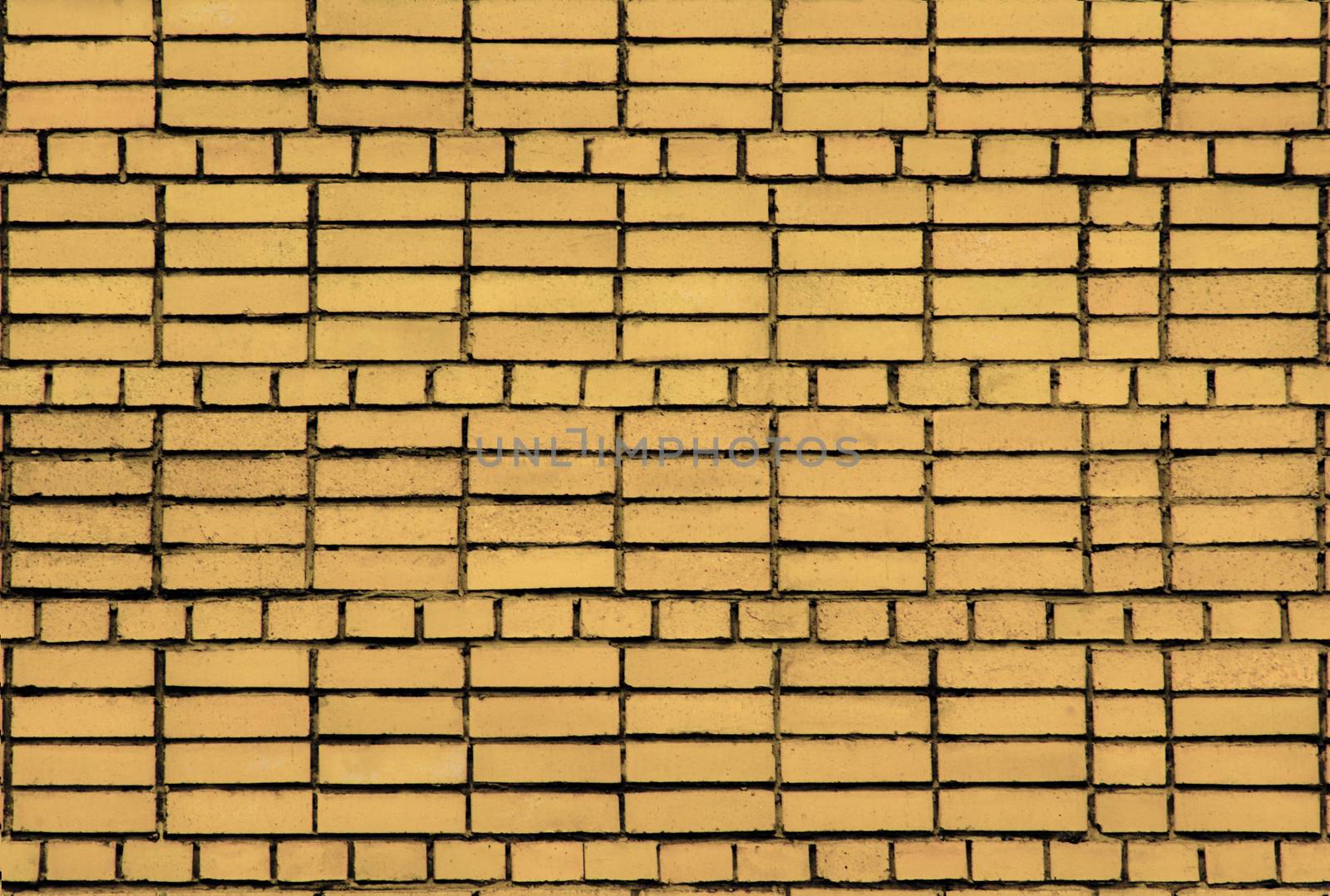 Brickwork of yellow bricks on cement mortar. by Igor2006
