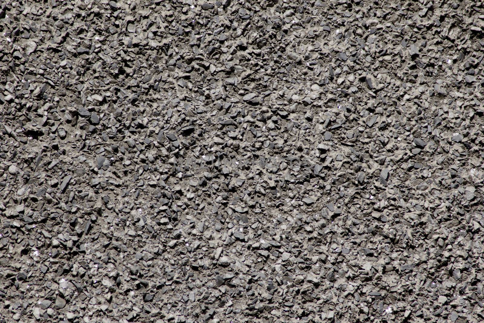 The wall consists of stone chips of dark color on a flat surface.