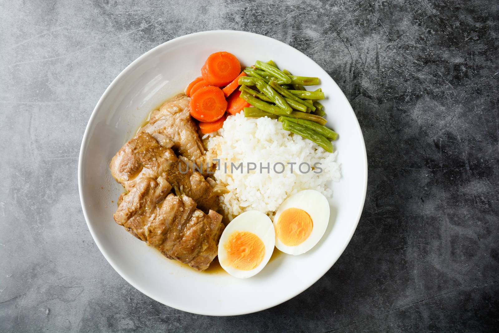 Baked pork ribs with rice, boiled egg and vegetable