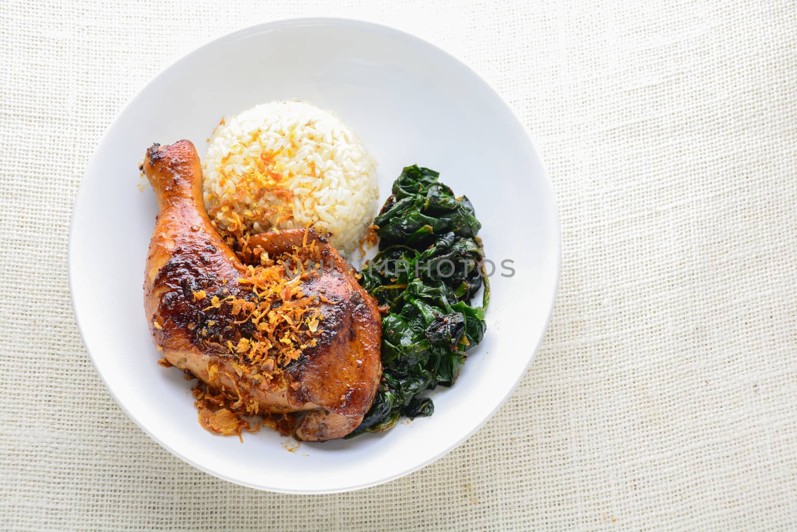 Chicken drumstick marinated with spicy chilli sauce and herbs, served with cooked rice and spinash.
