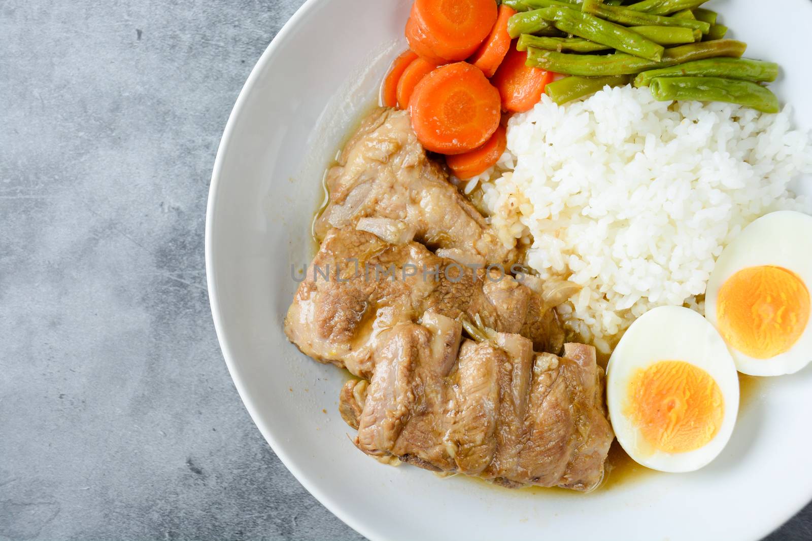 Baked pork ribs with rice, boiled egg and vegetable