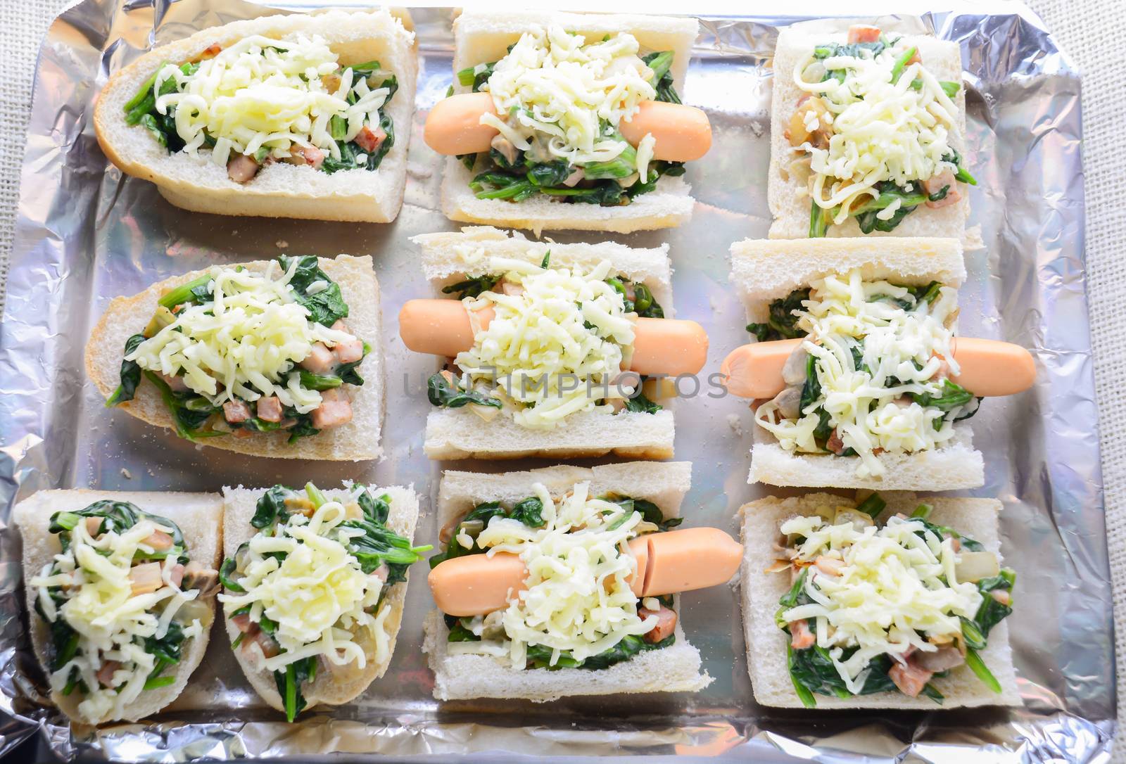 Baked Spinach with Cheese, sausage on Baguette, French bread by yuiyuize