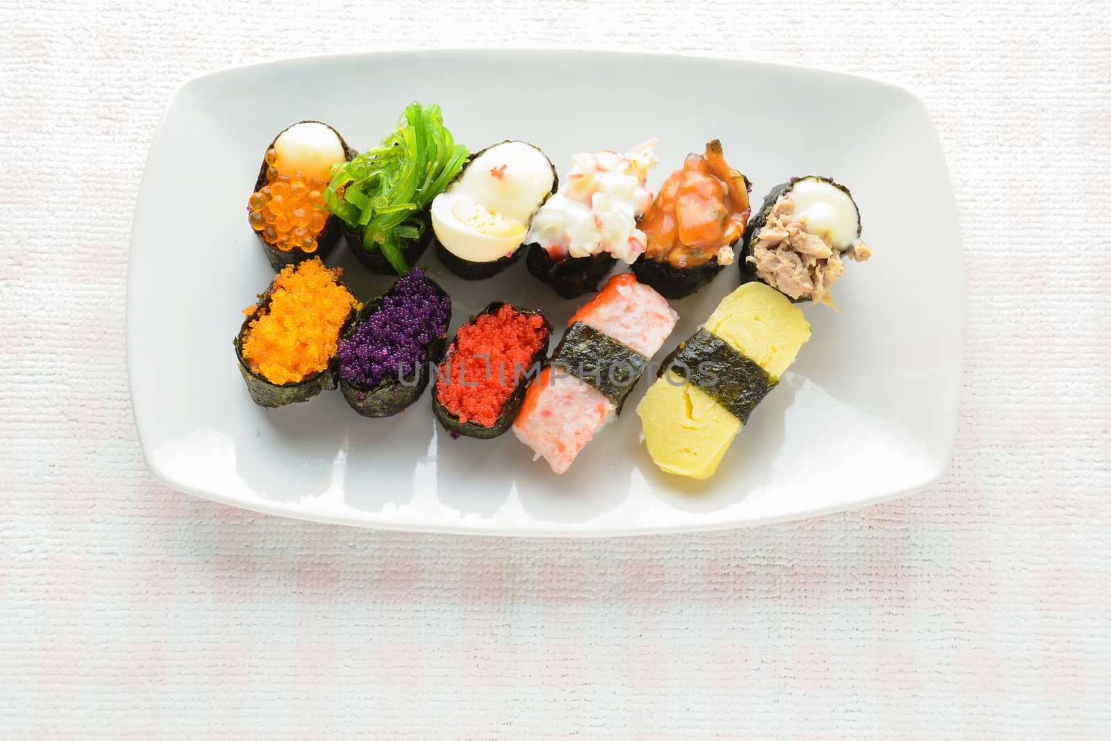 Sushi on white plate, tuna, salmon, sea bass, sweet egg, shrimp sushi, Japanese food
