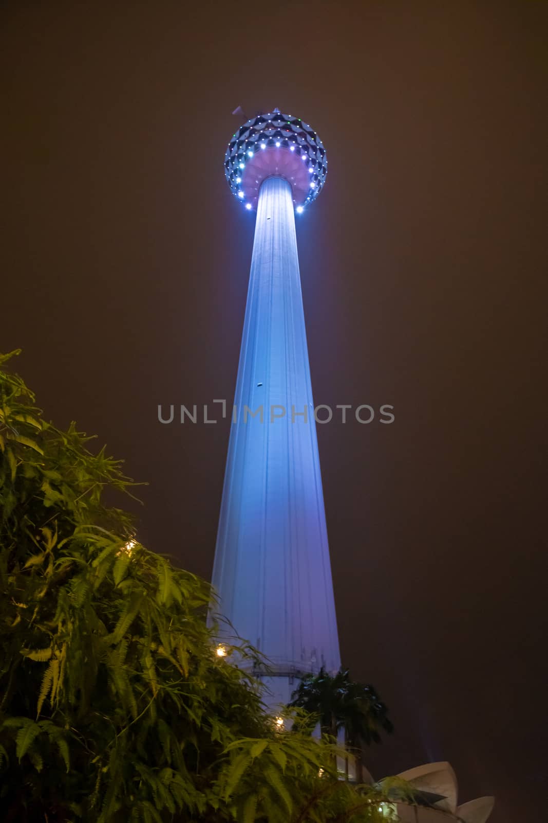 Blue illuminated big transmission tower in Kuala Lumpur Malaysia by MXW_Stock