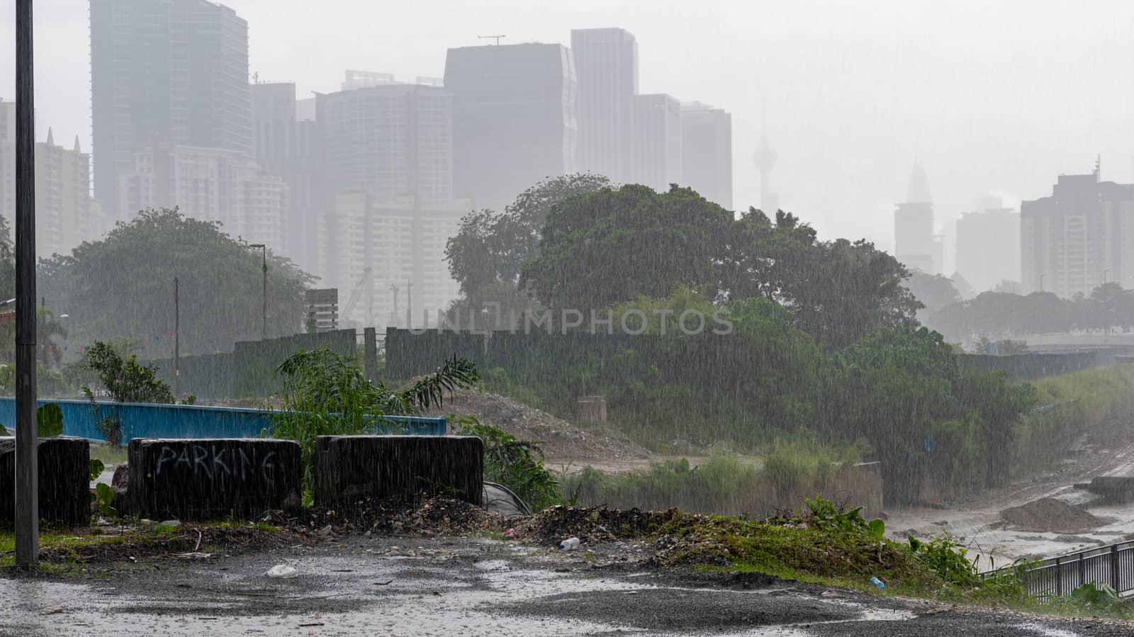 Heavy rainfall hitting Kuala Lumpur during monsoon season in Malaysia by MXW_Stock