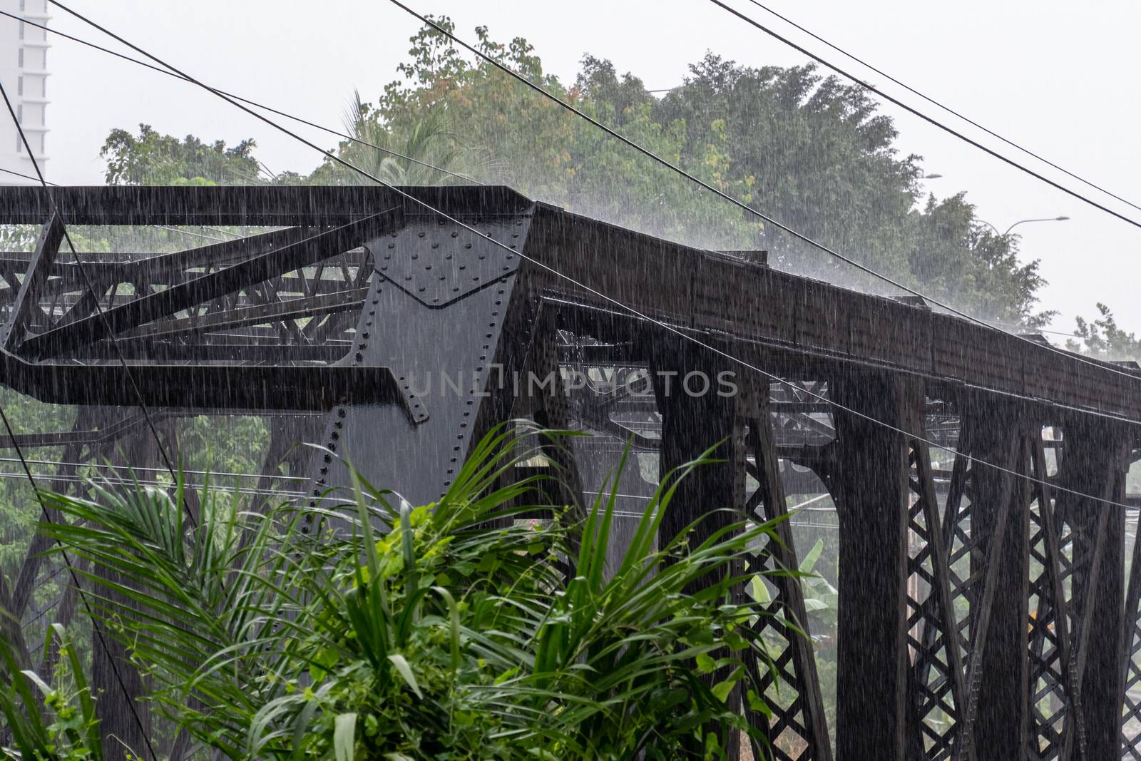Heavy rainfall hitting steel structure during monsoon season in Malaysia by MXW_Stock