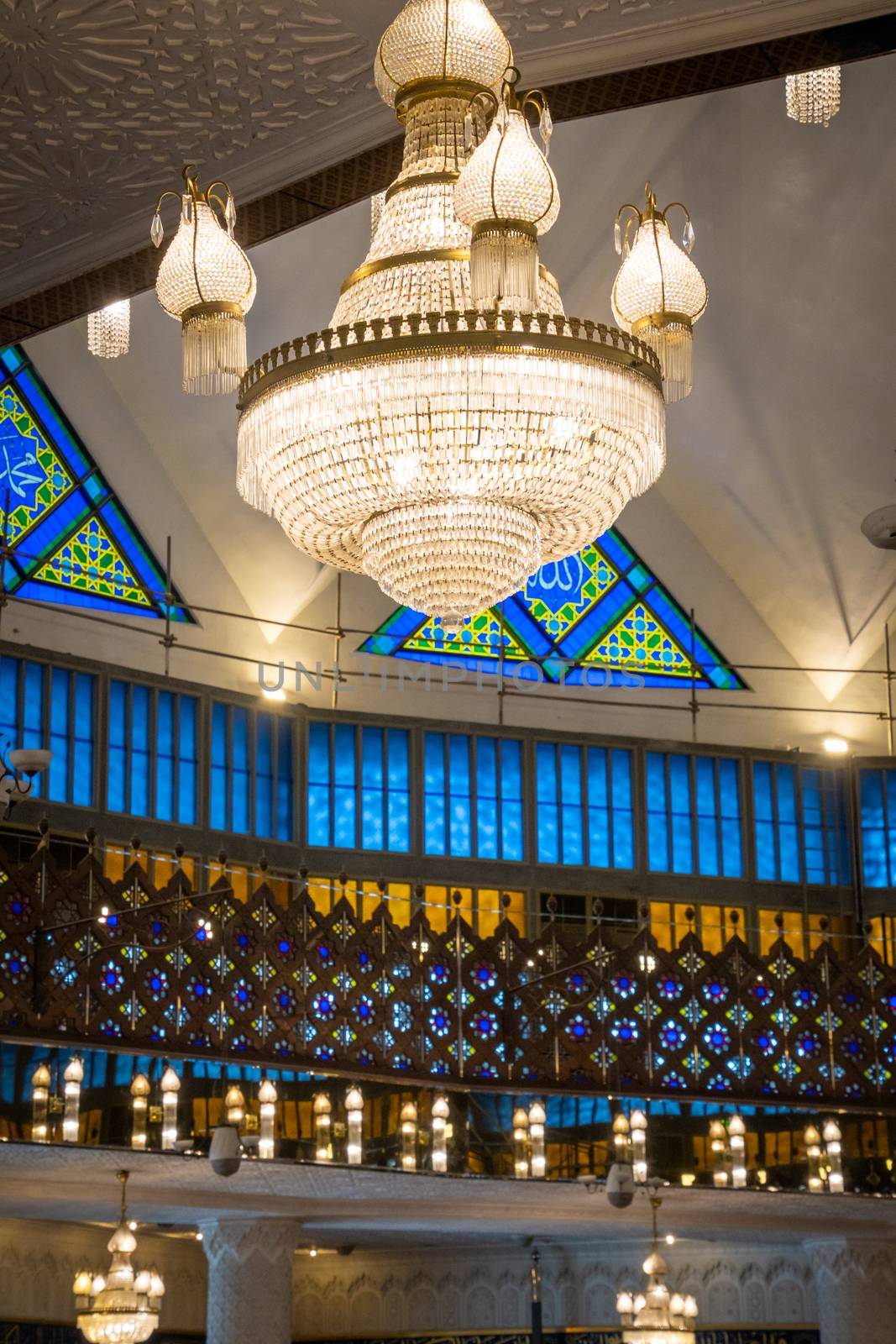 Masjid Negara mosque chandelier and colored windows inside in Kuala Lumpur by MXW_Stock