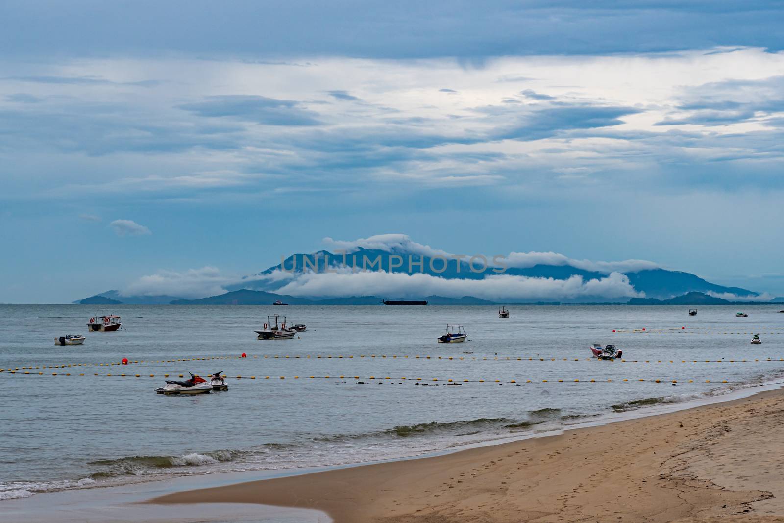 Penang island deep mowing clouds close to the beach in Malaysia by MXW_Stock