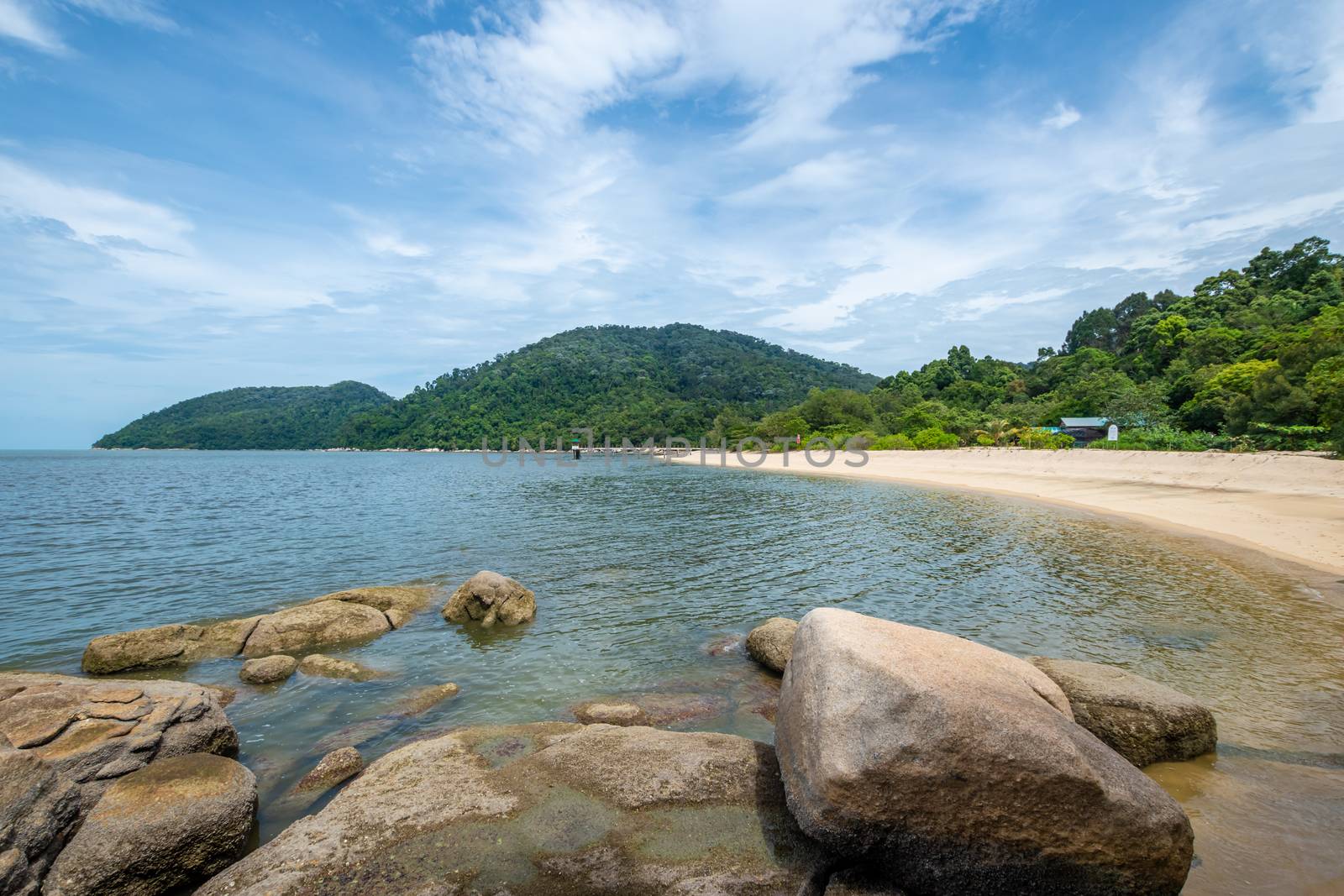 Penang island beach next to the tropical rain forest of Penang National Park by MXW_Stock