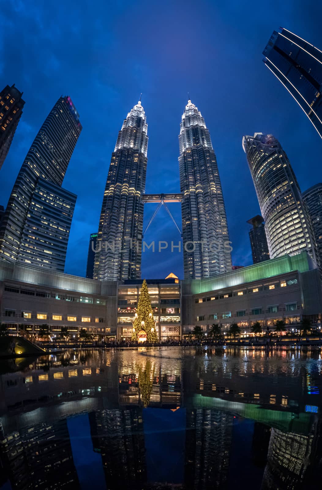 Petronas twin towers panorama with illuminated christmas decoration in Kuala Lumpur Malaysia by MXW_Stock