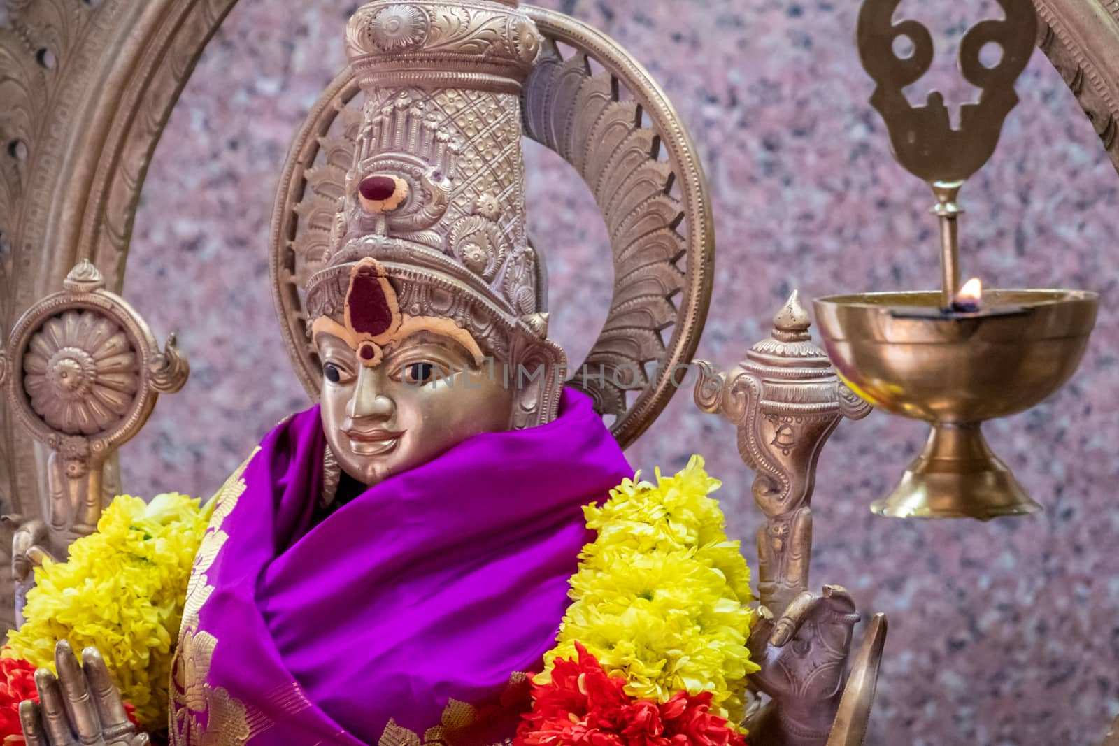 Sri Mahamariamman Temple golden statue decorated with gifts