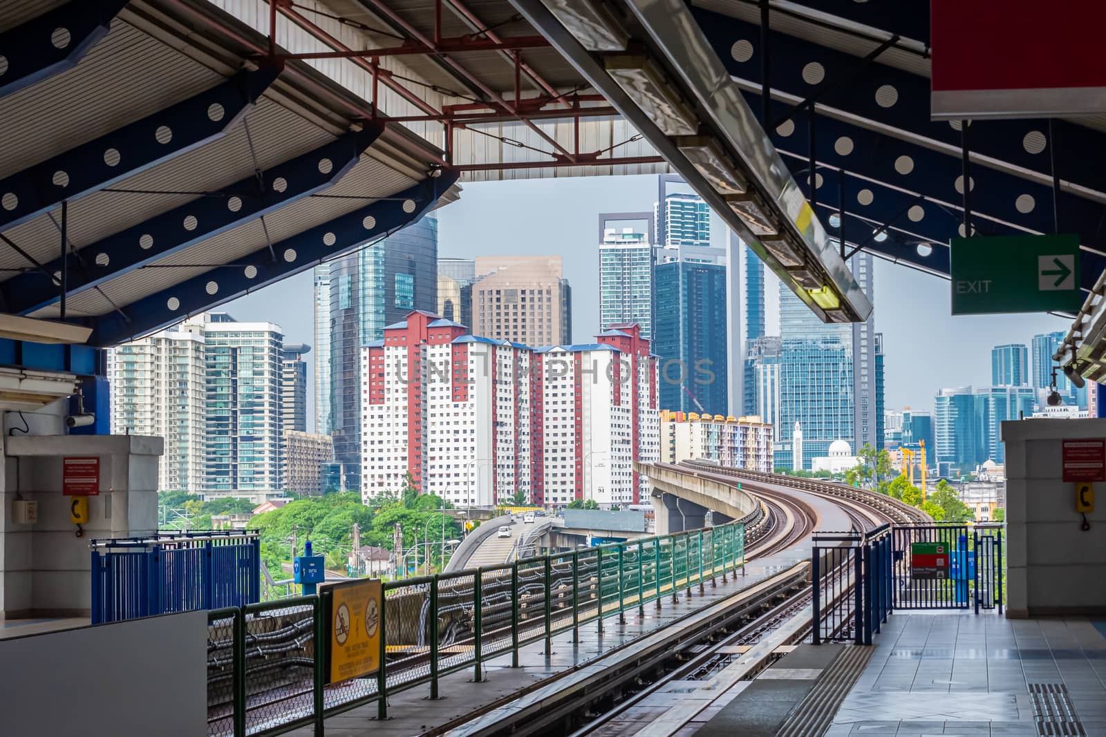 Tramway station in Kuala Lumpur showing skyline of city center in Malaysia by MXW_Stock