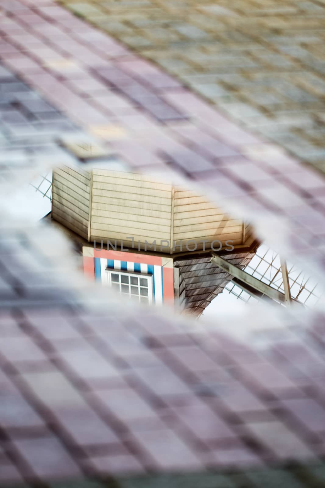 reflection of windmill replica in the water