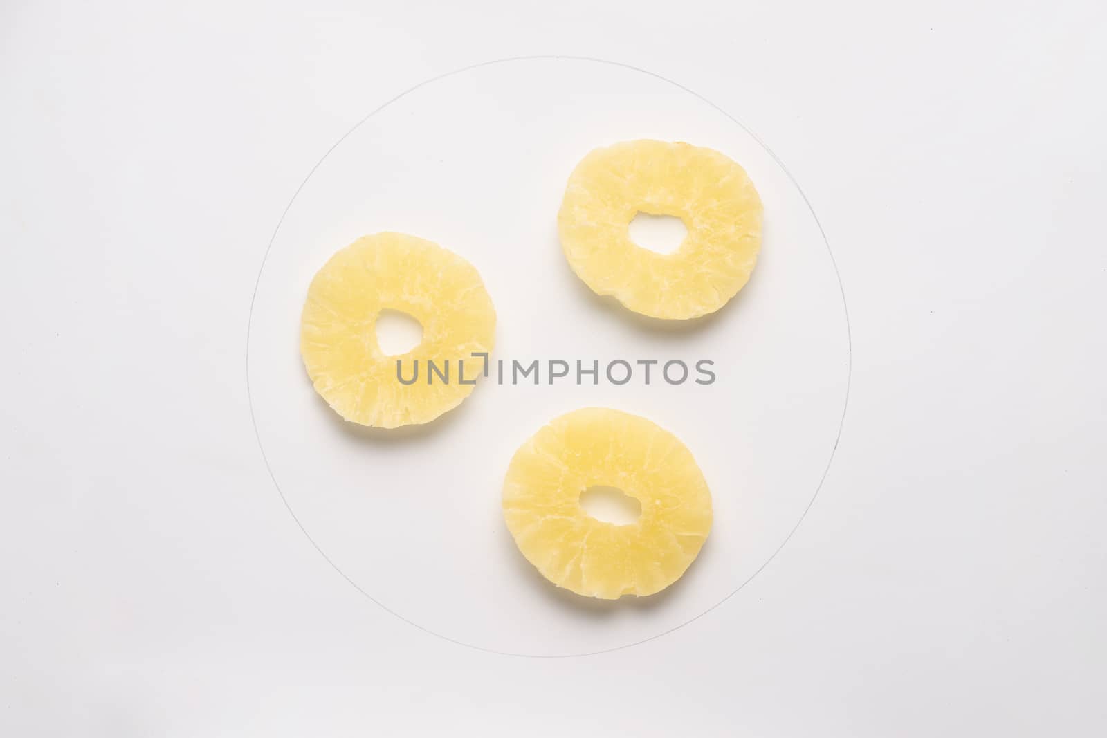 Candied pineapple round chips isolated on white backgroud. 