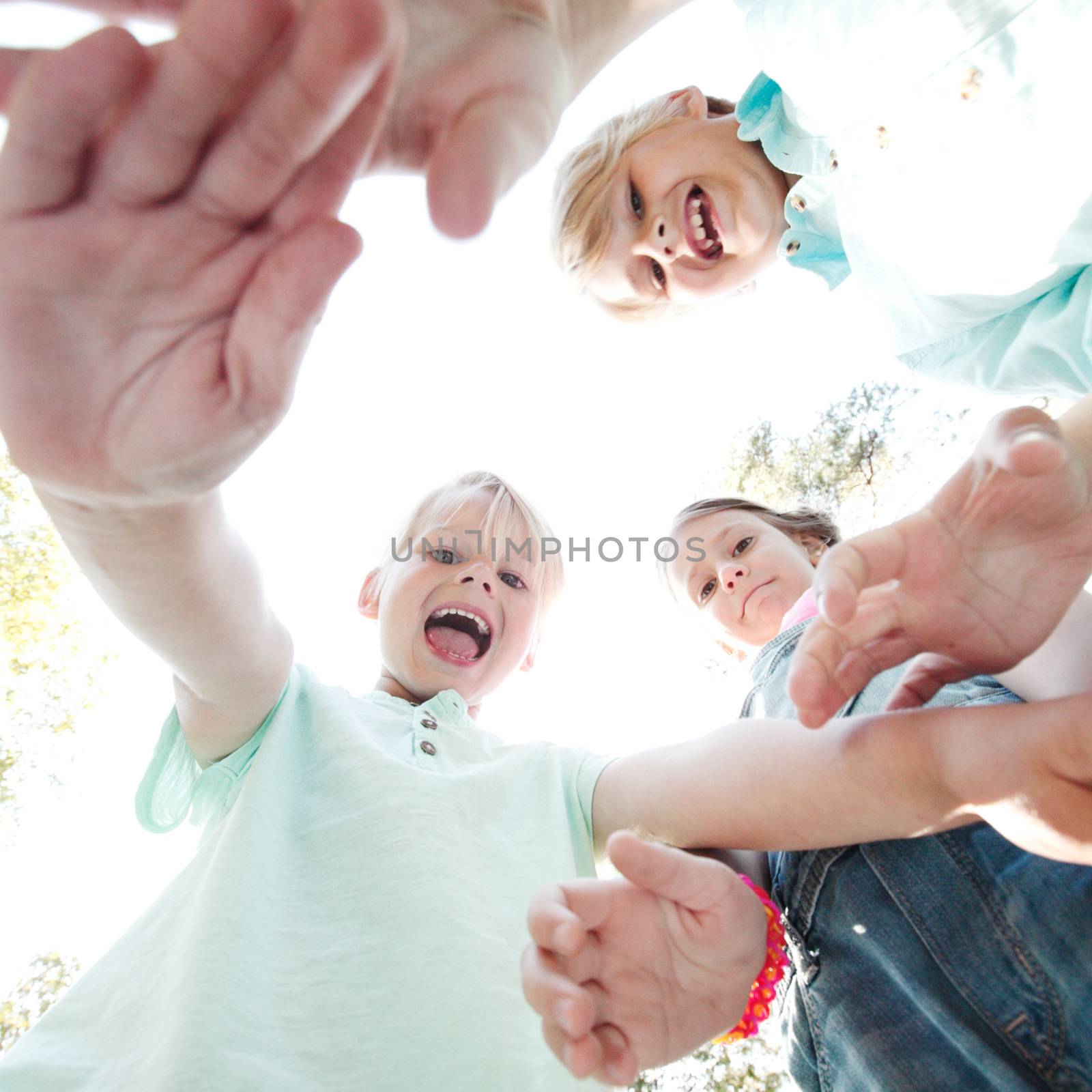 Group of smiling children looking down into camera