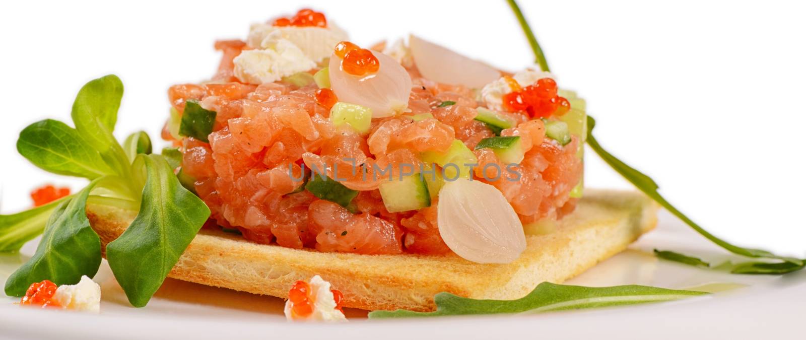 The tartare of salmon on a bun close up by SvetaVo