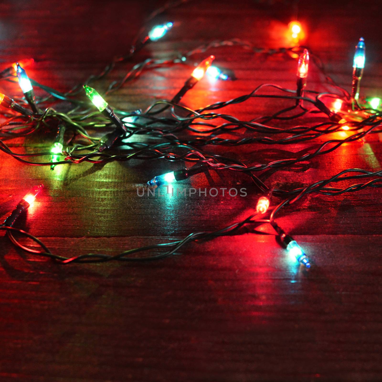Christmas garland with lights on wooden background by SvetaVo