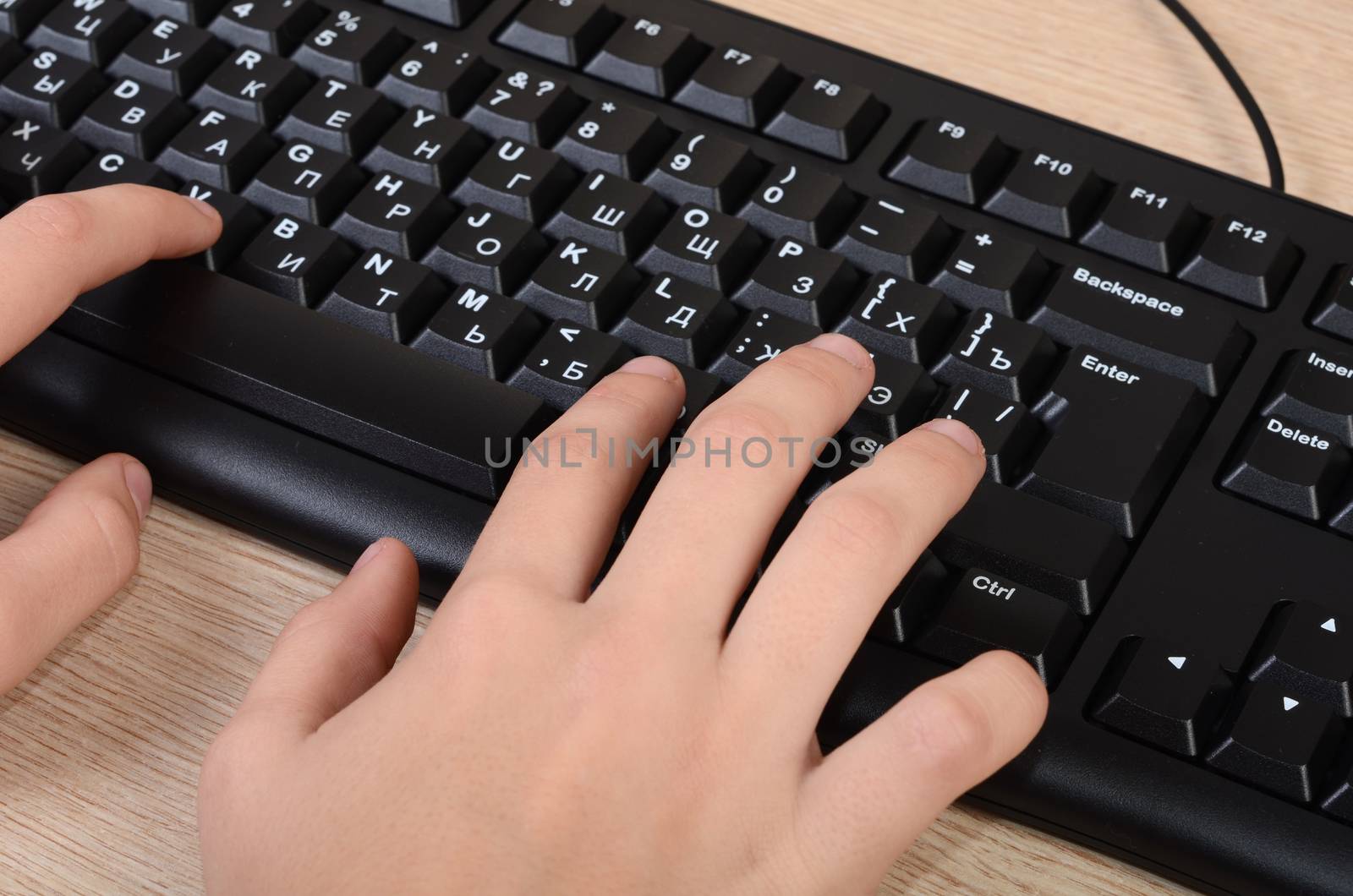 The women's hands typing on the keyboard