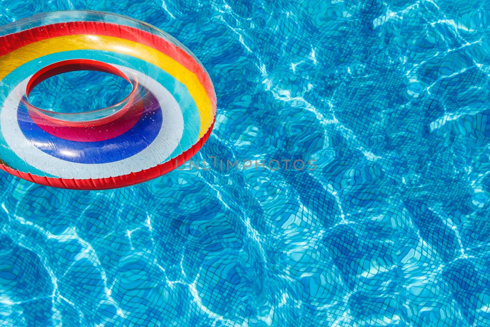 Inflatable water activities circles tuba float on the water in the pool. banner. Concept, fun, perky summer and relaxation. by Tanacha