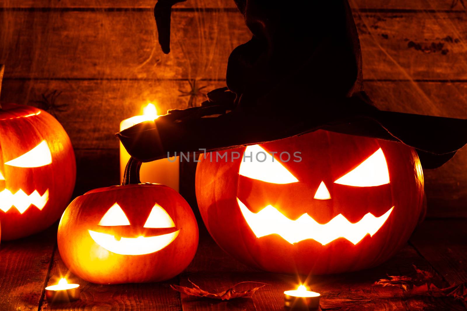 Jack O Lantern Halloween pumpkin with witches hat and burning candles