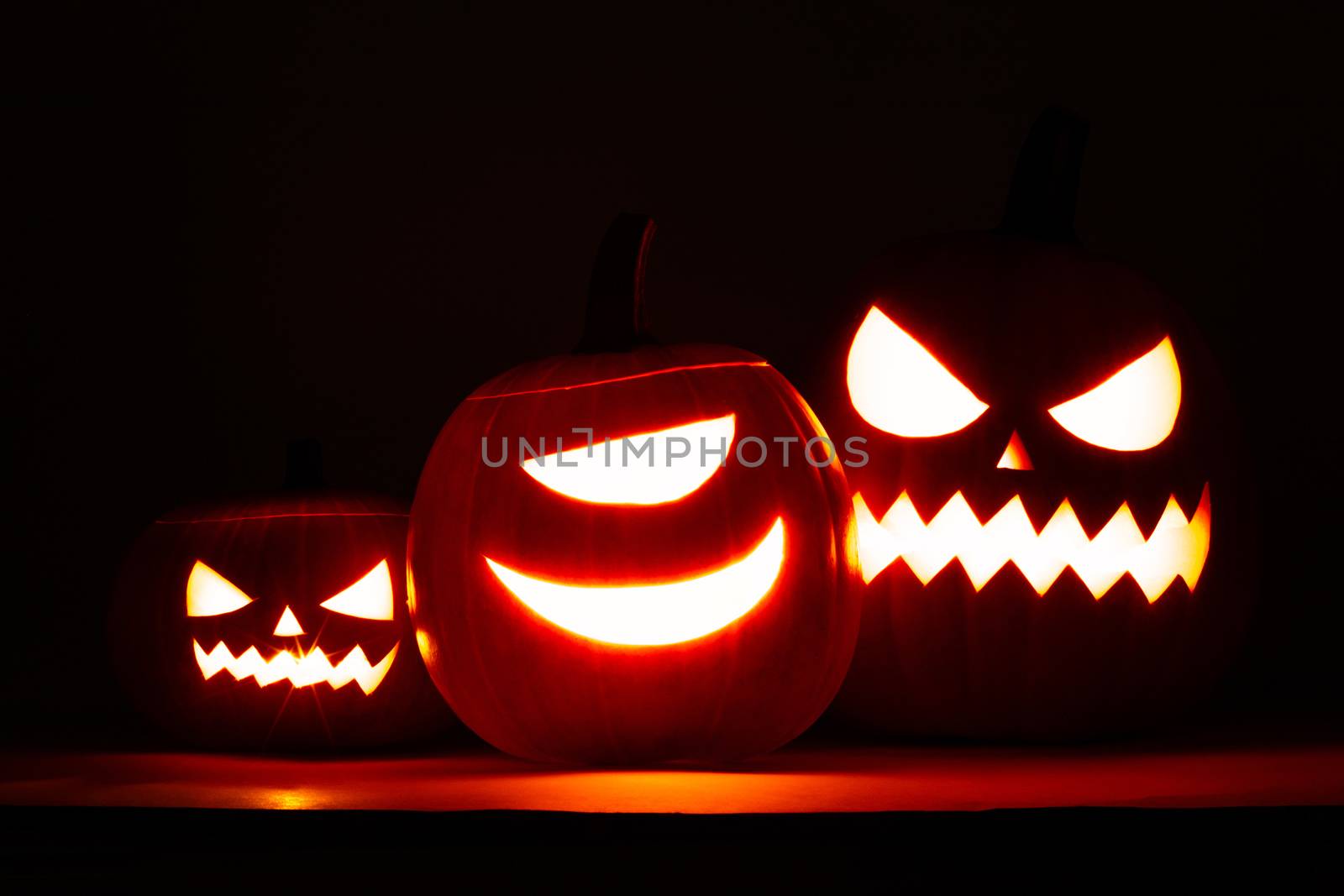 Group of Halloween pumpkin heads jack o lantern on dark background