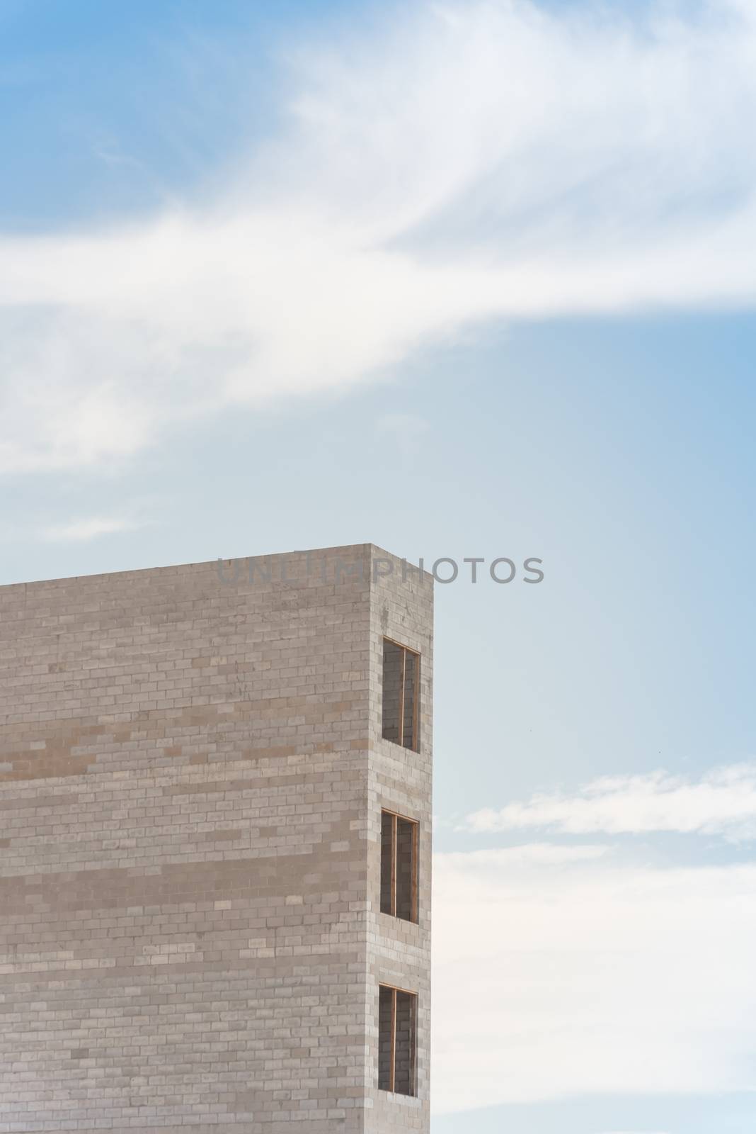 Close-up of elevator shaft for a new condominium building under construction in Richardson, Texas, America. Lookup view of concrete elevator tower under cloud blue sky