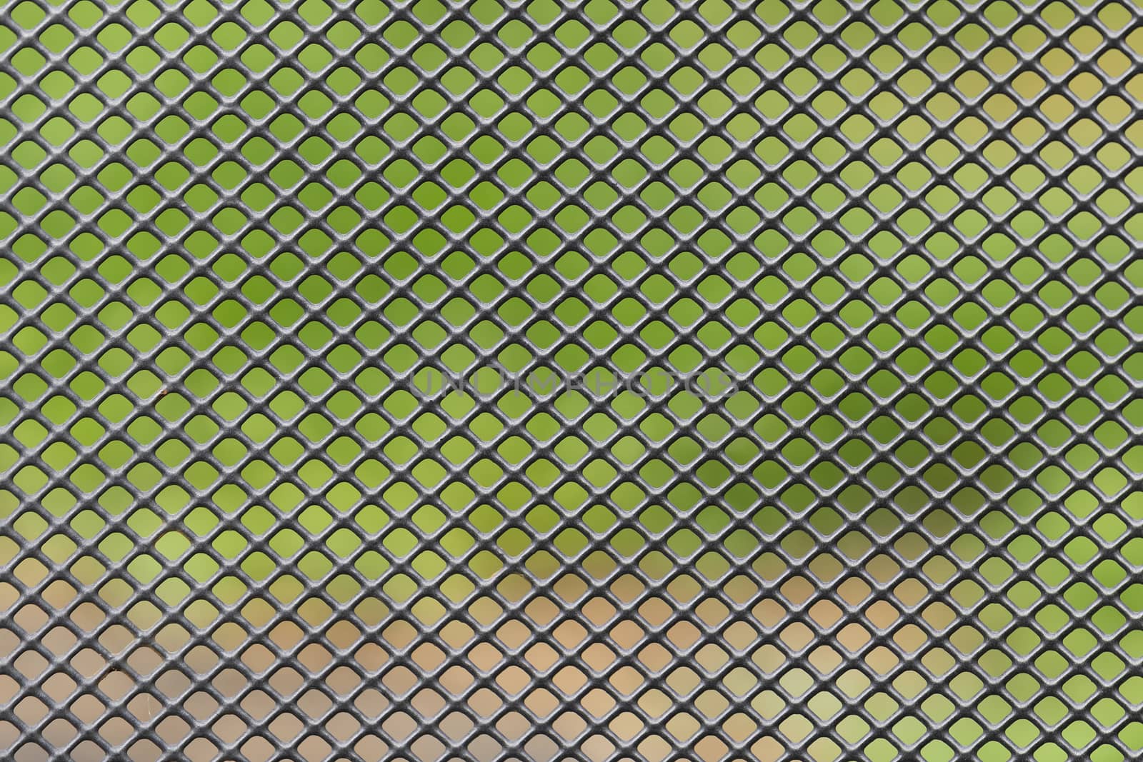 Metal grid with blurred green brown background
 by Tofotografie