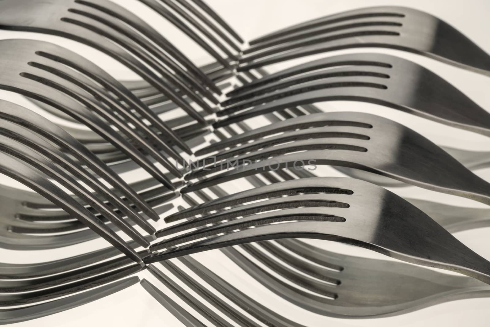 Abstract artistic picture of wavy forks, which form a wave pattern by means of mirroring
