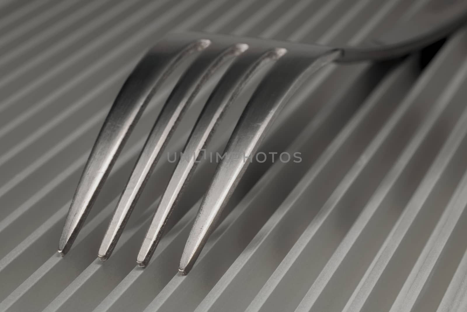 Abstract artistic picture of forks on a parallel grid structure
