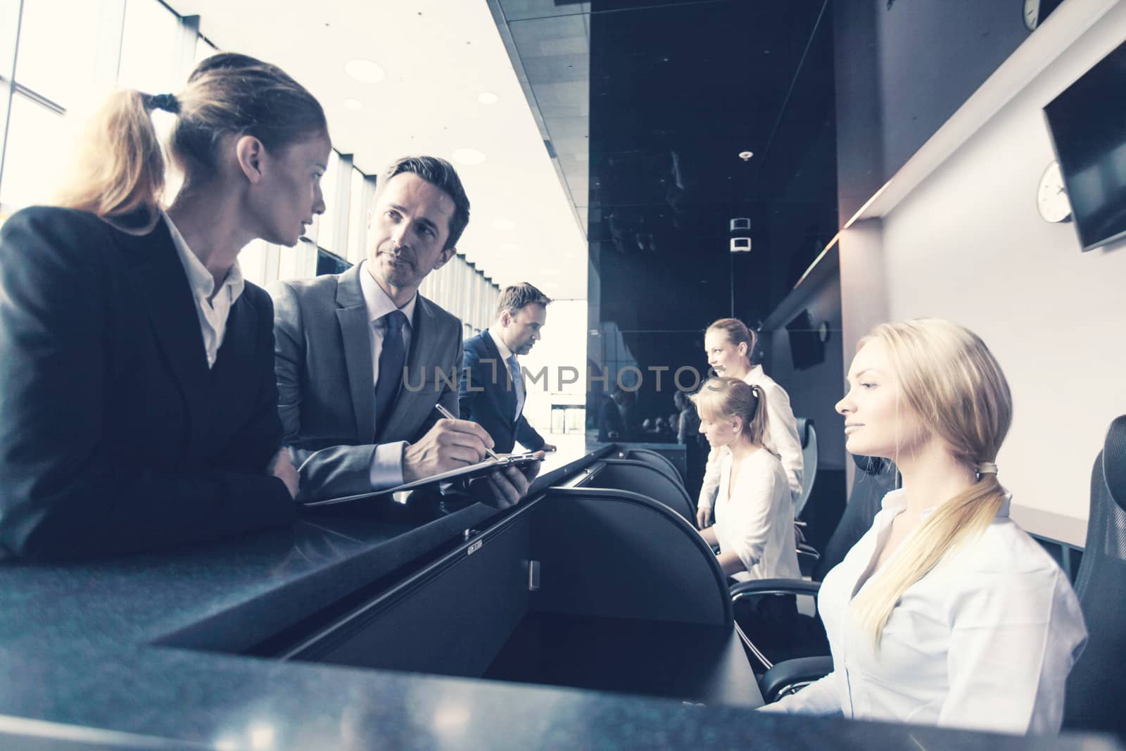 Business people filling forms at reception front desk toned image