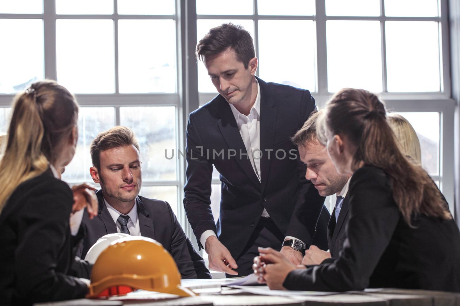 Group of Architects planning construction together at business meeting