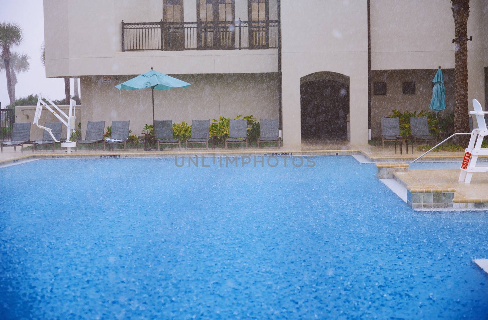 Outdoors swimming pool under the heavy rain by Novic
