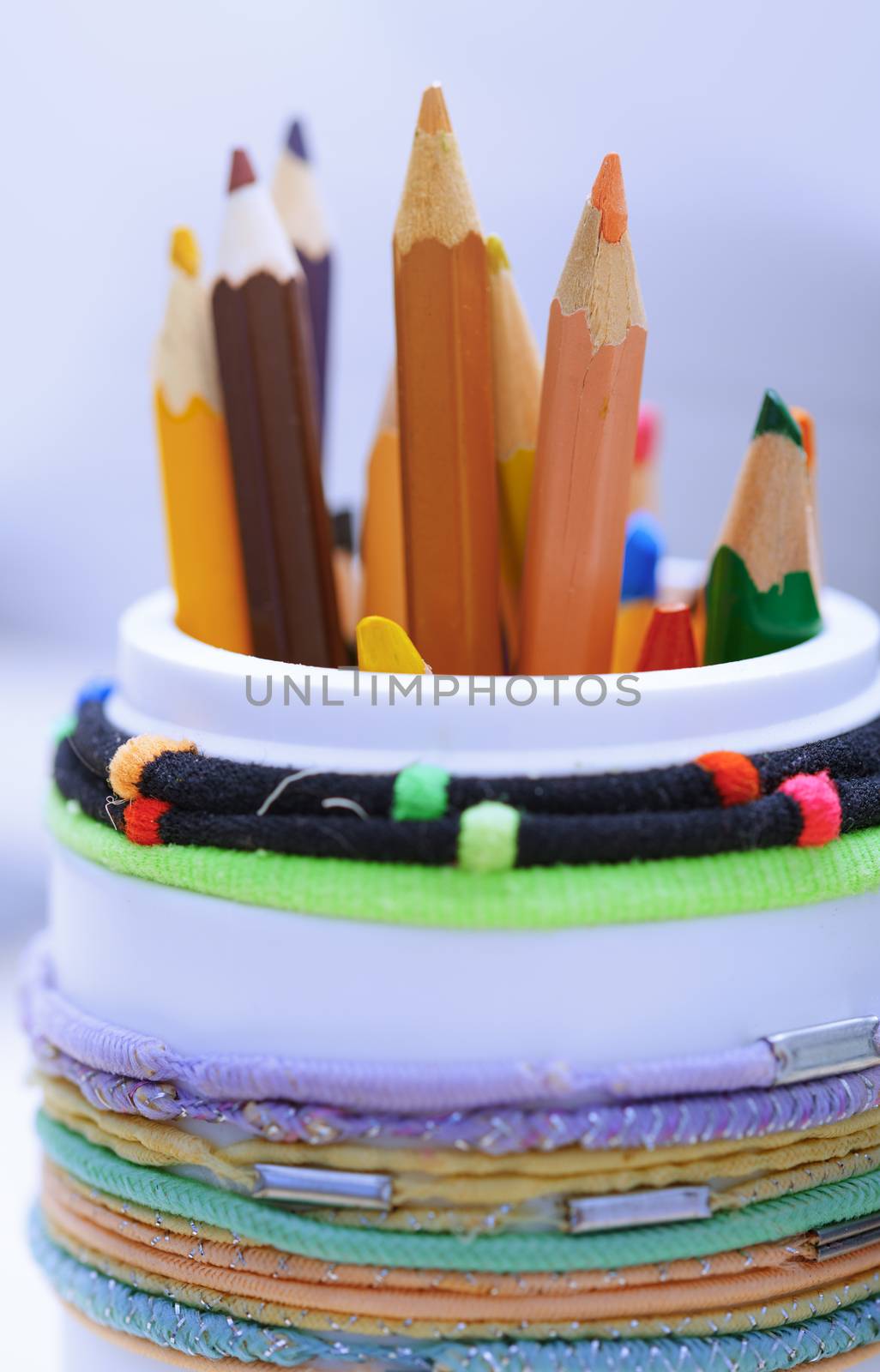 Color pencils in the plastic jar. Close-up