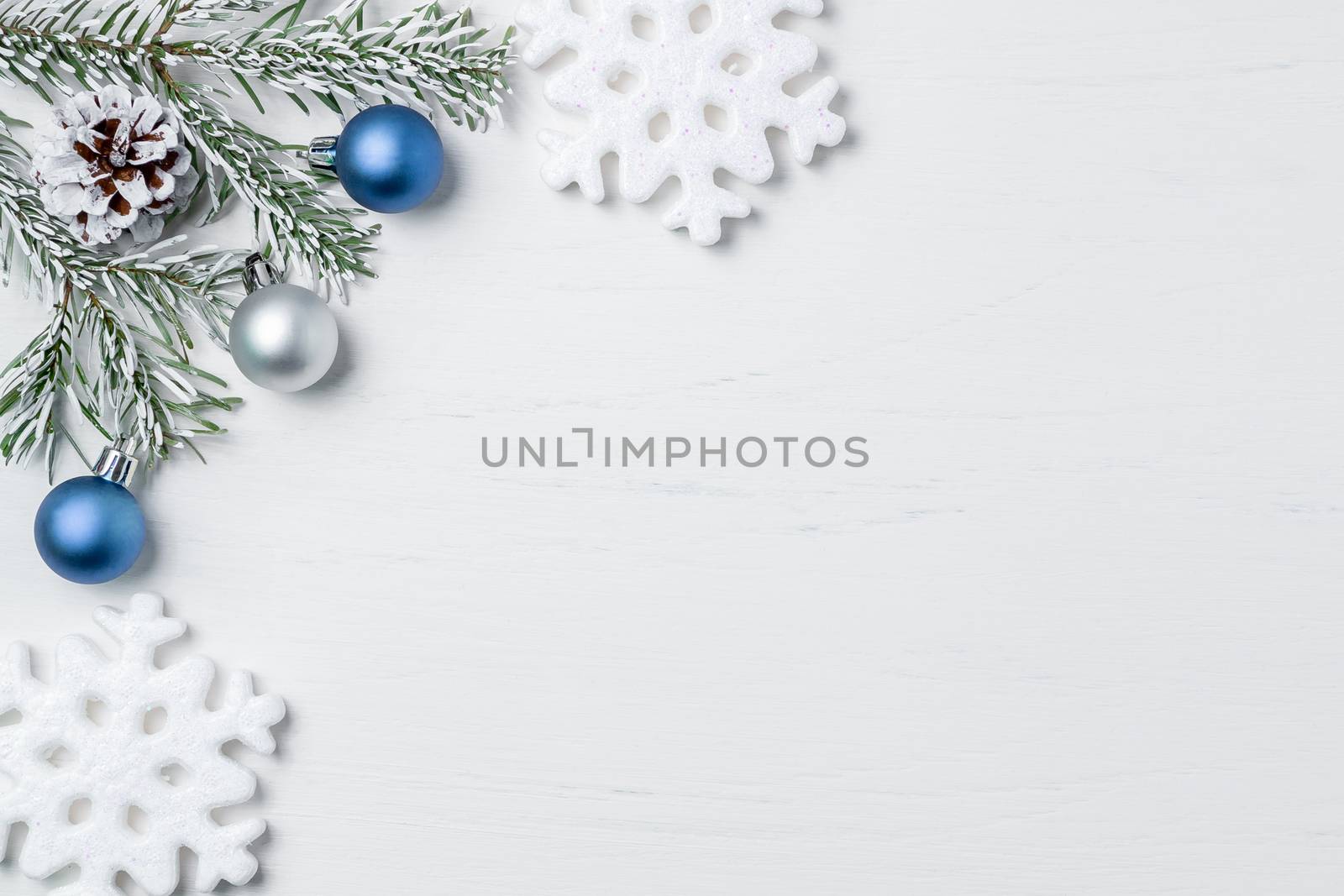 Bright Christmas composition, blank for design - snowflakes, Christmas tree branches and cones, copy space, place for text, flatlay.